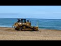 Cat D6 , D5 and D6N pushing sand on beach