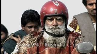 Bearded Sadhu rides decked-up bike and reads newspaper