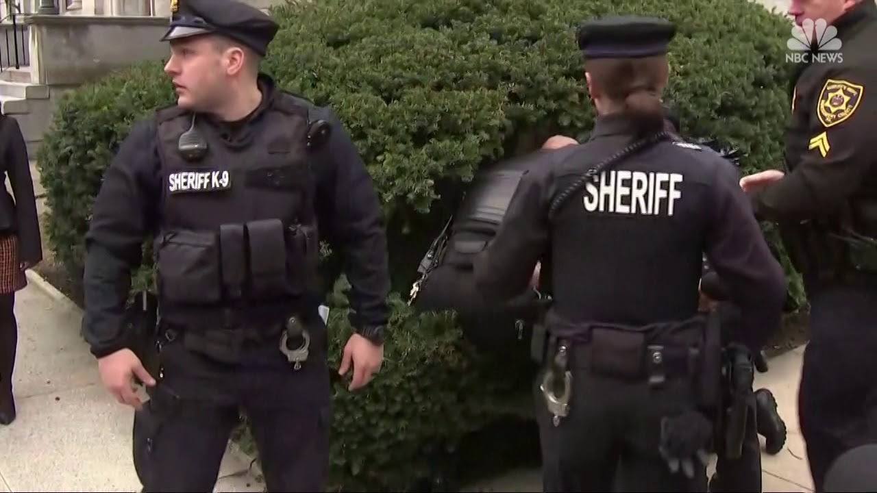 Topless protester charges at Cosby, arrested