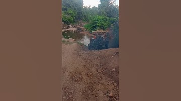 Xe công nông cầu đẩy chở mì vượt sông lên dốc