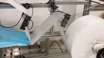 Adjustment of fabric rolls of flat face mask machine