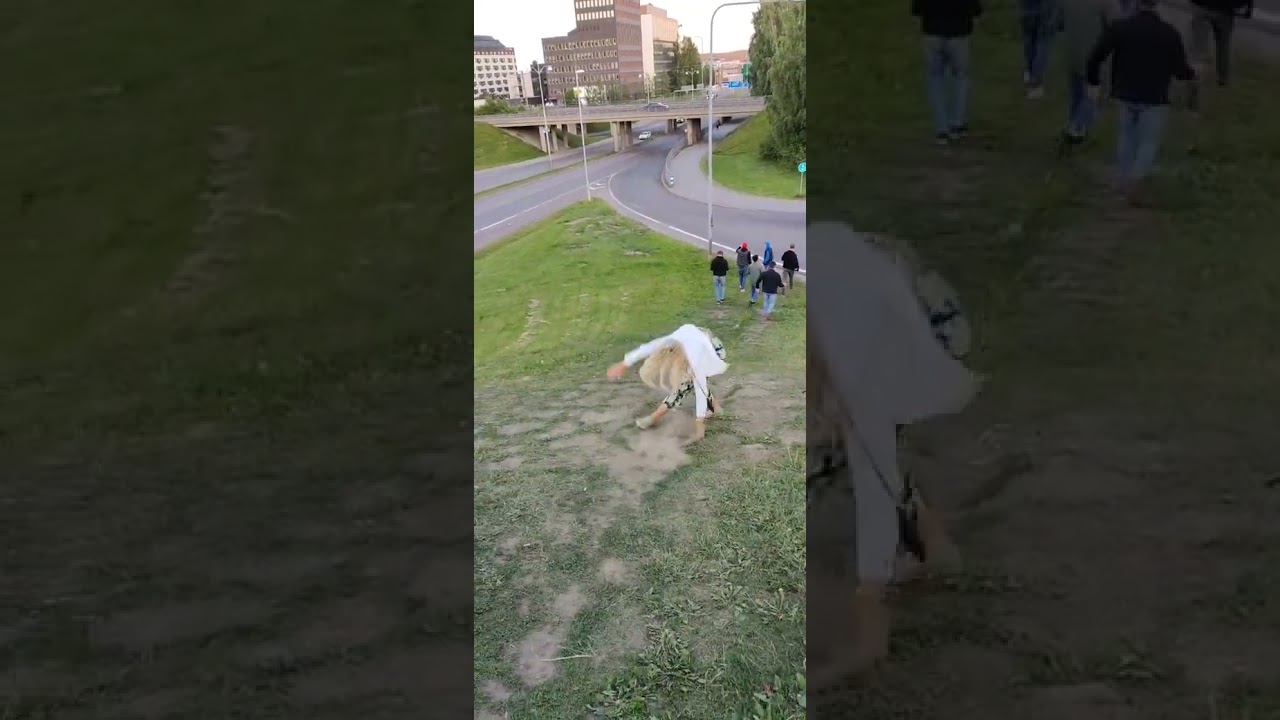 Girl runs down grass hill and faceplants