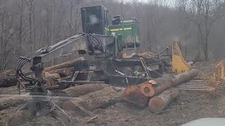 Finishing repairs on John Deere knuckleboom log loader
