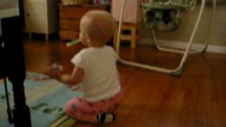 Cora Grace crawling around with a teether in her mouth