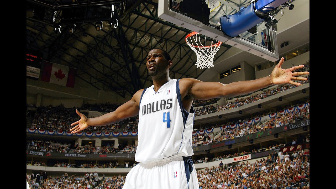 Michael Finley of the Dallas Mavericks shoots a jump shot over Jim