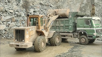 Big Cat-966D Model Wheel Loader Loading Huge Rocks into Hino, Nissan and Howo Dumpers
