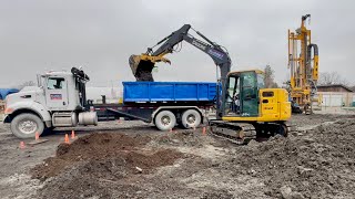 Excavator Loading Dirt Into a Bin Truck