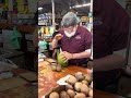 Professionally opening fresh, cooled coconut at Robert is here in Homestead, Florida