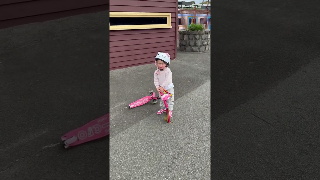 Little girl in white helmet falls off unicorn scooter just as Dad praises her for her cool tricks