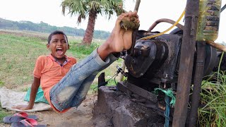 water pump machine start big Eastern village boy. Old 16 hp machine start.