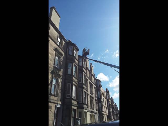 Cleaning Tenement Gutter in Edinburgh using cherry picker.