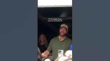 Thumbnail of Travis Kelce wearing a #TeamUSA cap, singing Lover at Taylor Swift concert. 📹: raeannlangas