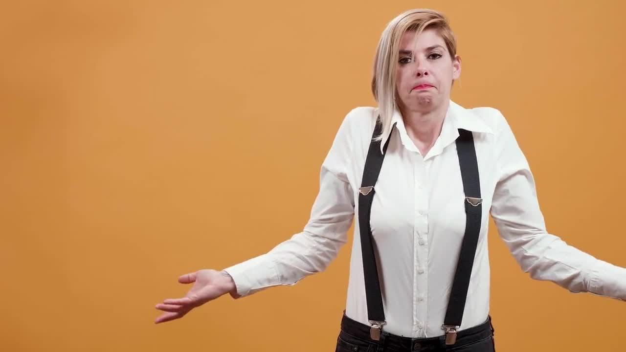 Confused Woman Shrugs Shoulders Stock Video