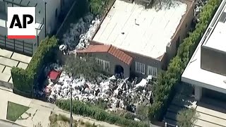 Cleanup begins at Los Angeles 'trash house'