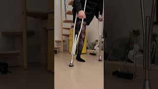 Rose polio woman letting her deformed paralyzed leg dangle between her crutches
