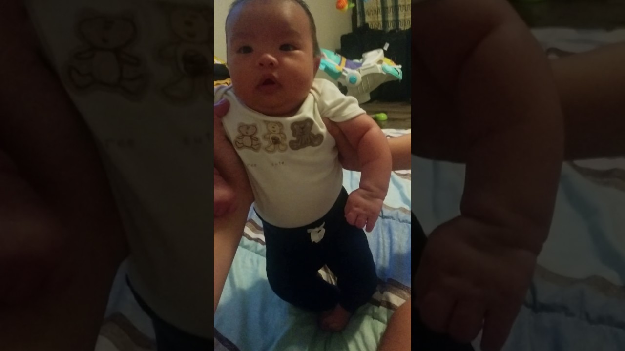 baby standing at 2 months