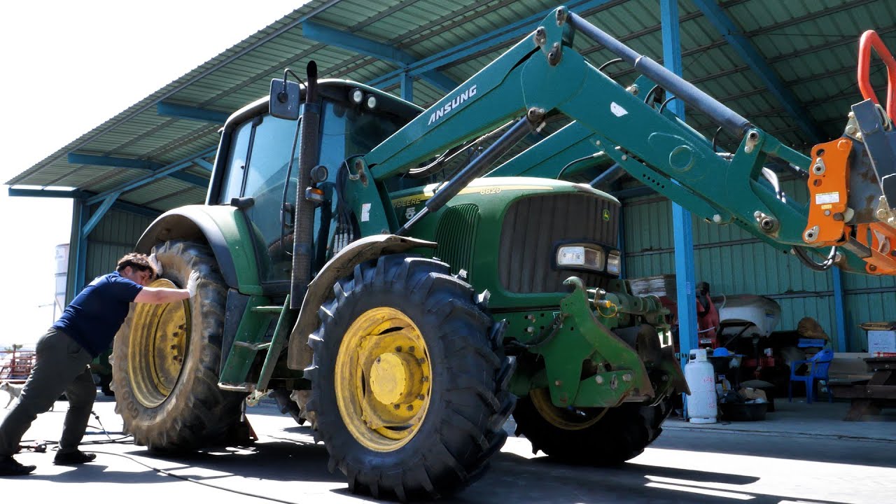 Process of Replacing Old Tires of Large Tractor. Korean Tire Engineers.