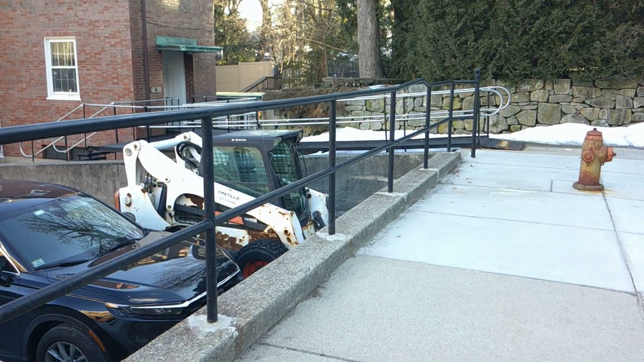 skid steer bobcat parked in business parking lot cambridge ma