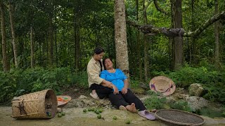 A young woman helps an elderly woman escape danger in a secluded area.
