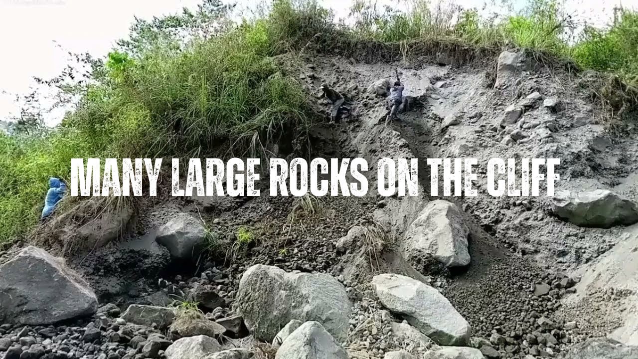 many large rocks on the cliff are being mined