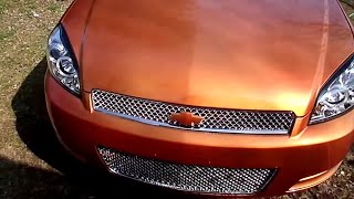 2006 Chevrolet Impala on 22's candy orange with Halo LED headlights