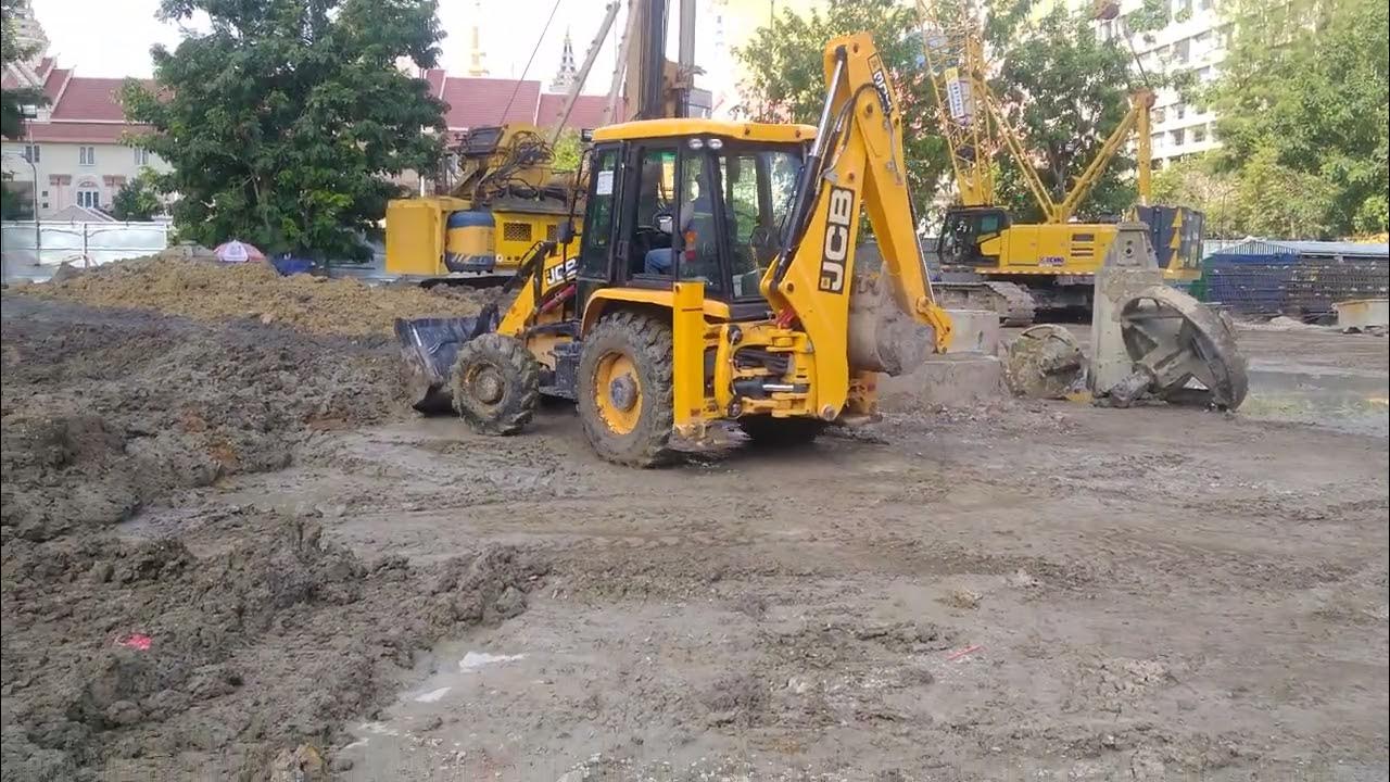 Activite backhoe machine push to clear the ground. YouTube