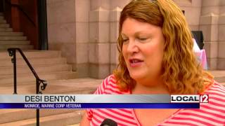 Opponents of military ban of transgender people rally at city hall
