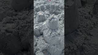 Brandon and Abigail build a sandcastle