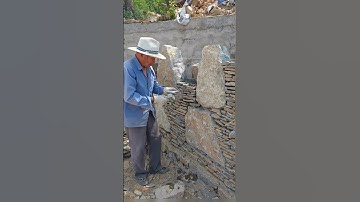The process of building a wall with stones