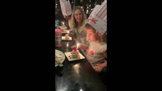 Little girl turns her head and fire from birthday candle burns he hair at hibachi restaurant