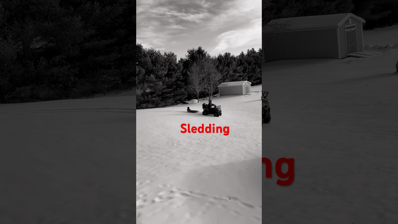 A four-wheeler pulling a sled through the snow, an example of smart winter ATV use.