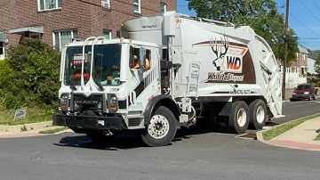 Whitetail Disposal Mack Mru Mcneilus rear loader with the orange logo
