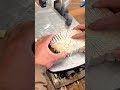 cutting wood piece using scroll saw machine to make traditional mask pattern neatly and carefully