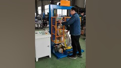 Vertical coil wrapper packing tires by stretch wrap