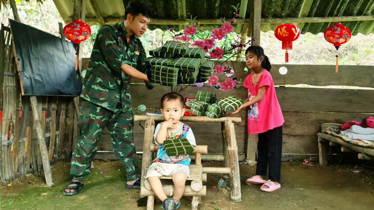 The devoted father wraps banh chung (Vietnamese rice cakes) for his two children. Single father.