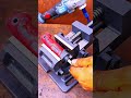 Rusty pipe clamped tight, workshop precision guides metal cutting."