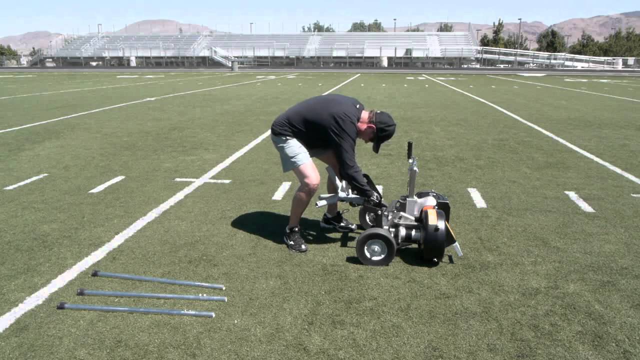 Attaching the Snap Attack Football Machine onto the stand.