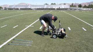 Attaching the Snap Attack Football Machine onto the stand.