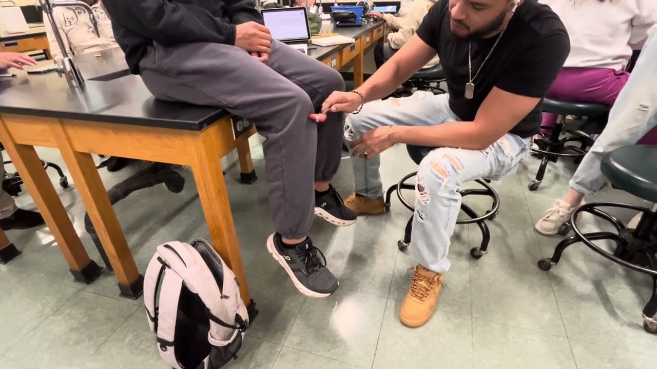 Premed & Nursing students learning how to assess reflexes