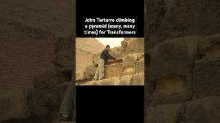 John Turturro climbing a pyramid @demyacon