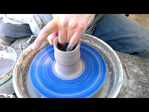 Video thumbnail showing a potter pushing the wall of a thrown pot back down toward the base