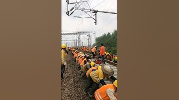 Laying railway tracks requires many workers to work together.