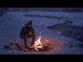 Relaxing by a Crackling Campfire near the Frozen River in the Mountains with Snow Falling Quietly