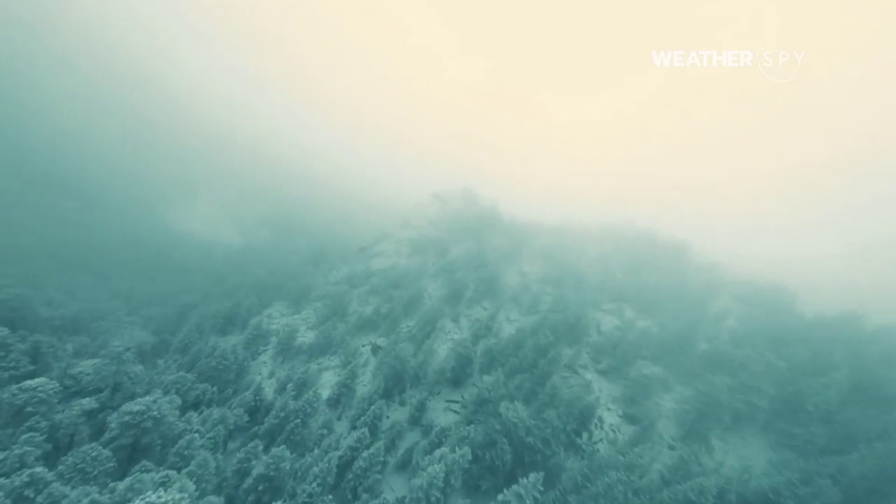 Racing Drone Captures Snowy Mountain Landscape