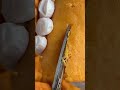 This is a food that is being cut using scissors into two parts.