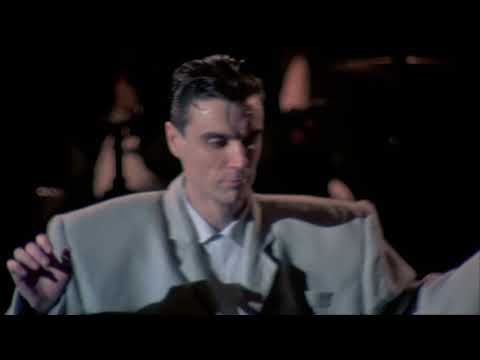David Byrne dancing in a big suit