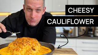 Whole roast cauliflower covered in a rich cheese sauce.