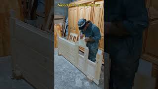 A skilled carpenter makes a red wood door quickly and efficiently
