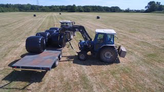 Loading, hauling and stacking haylage bales.