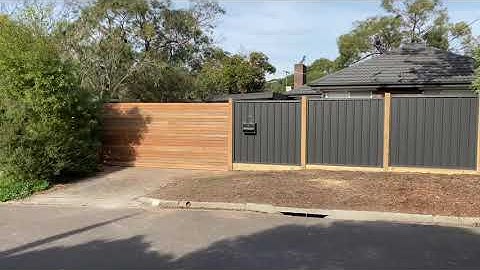 Front Colorbond fence exposed posts with spotted gum motorised sliding gate